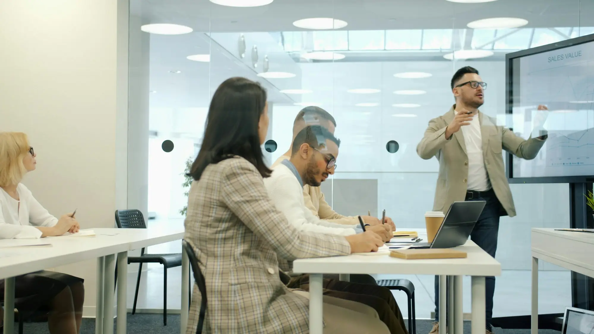 Manager explaining a new process to staff in a modern office