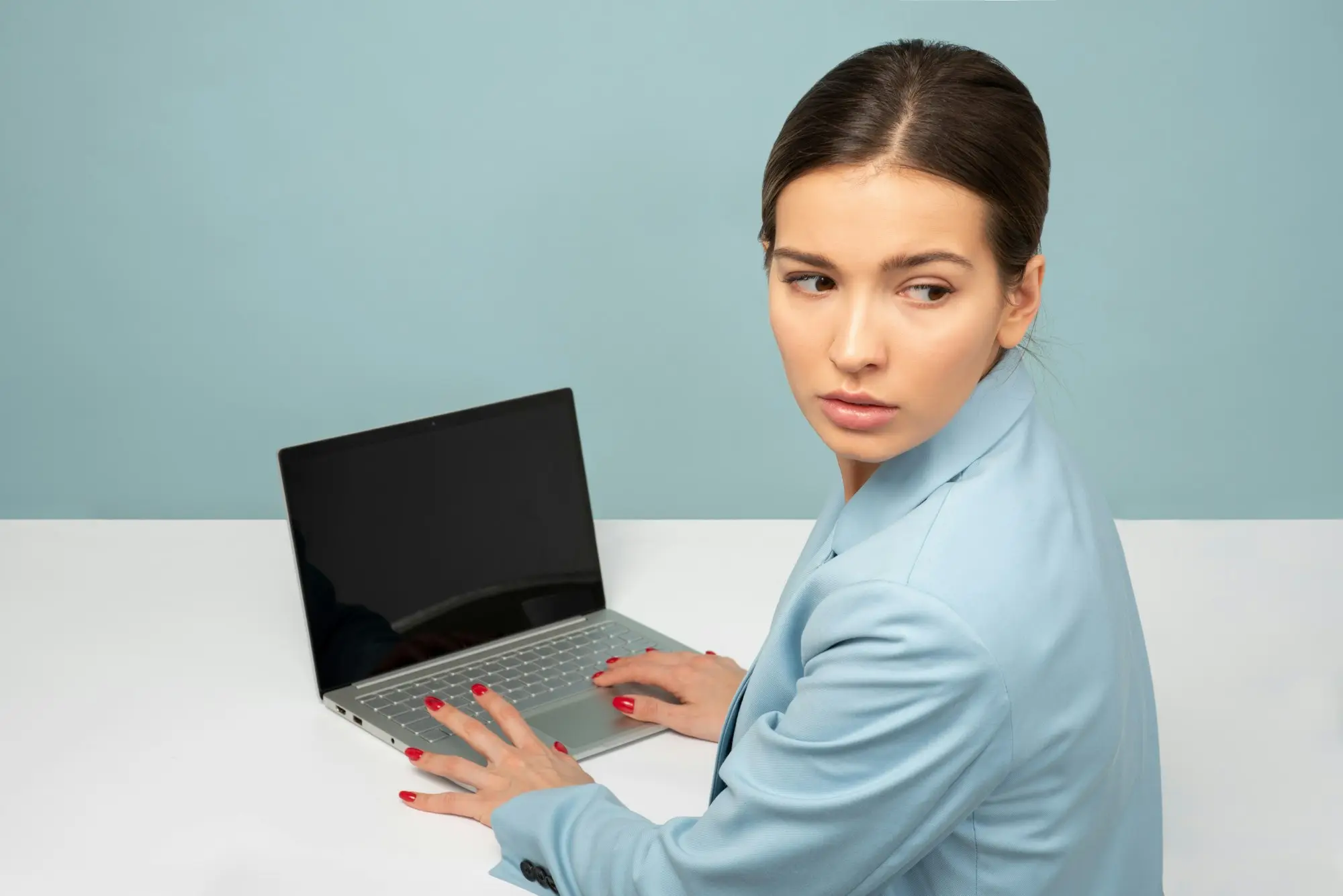 Worried business owner looking away from her laptop