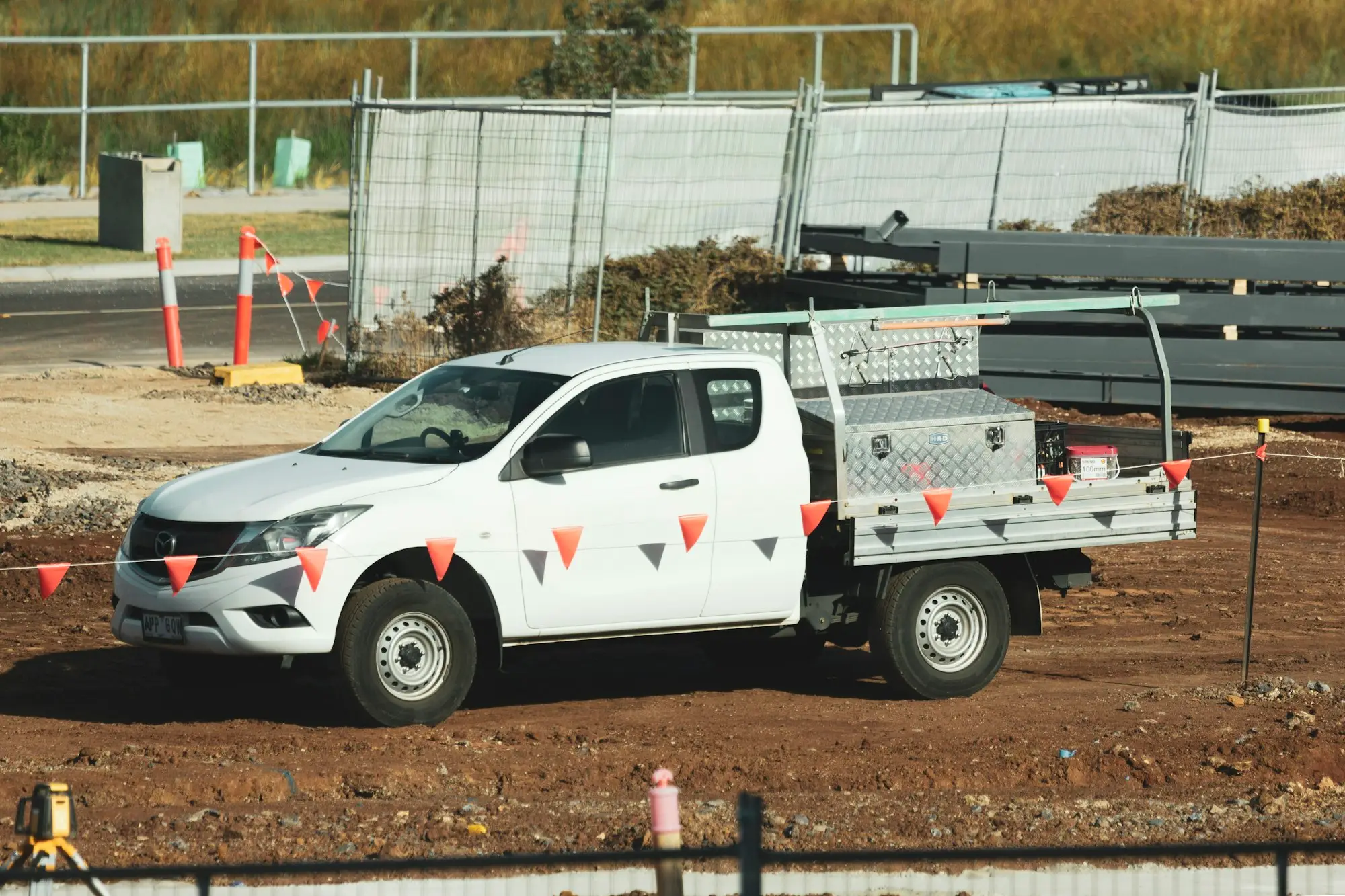White tray-back ute parked on a building site in Truganina, Victoria